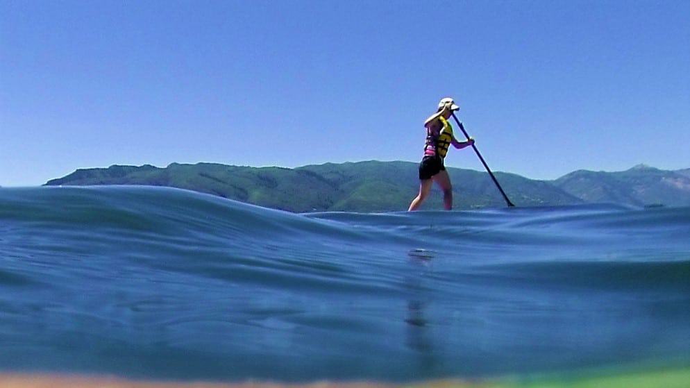 paddle boarder riding the best inflatable SUP board