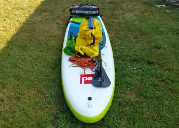 packing gear on a paddle board